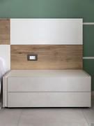 Headboard paneling detail with natural wood and white lacquer panels