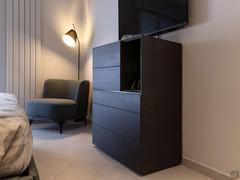 Wooden chest of drawers with an open top compartment.