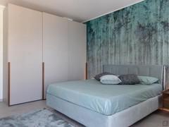 Double bedroom with bed and sliding door wardrobe.