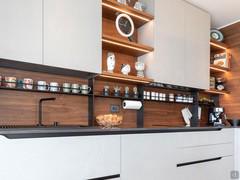 Kitchen splashback with cup and spice rack and hooks.