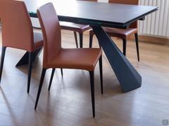 Black Industry painted metal table base detail and leather chair with solid wood legs