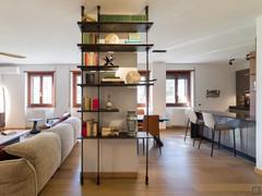 Modular pole bookcase with floor-to-ceiling attachment