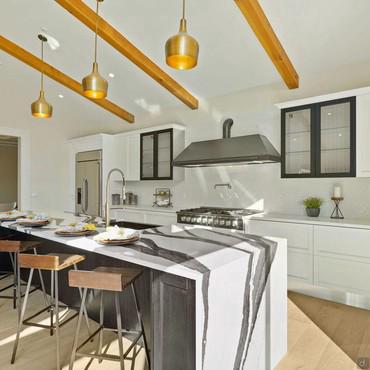 Kitchen with island with snack counter and sink integrated into the top