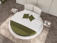 Upholstered round double bed upholstered in Pearl White leather, positioned in the centre of the room.