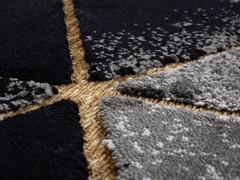 Detail of two-thickness fleece with black/gray plush and gold inlays