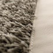 Detail of Coimbra sand rug with pearl nappa eco-leather edge