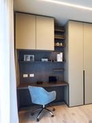 Wide back shelves used to create storage space for books and various objects in a study corner. An umber shine painted metal shelf is also visible