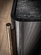 Details of the wooden sideboard body with curved edges and the lowered marble top