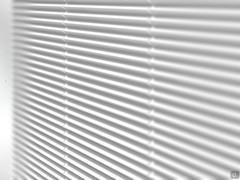 Details of the linear pattern on doors and sides of Fado cupboard, lacquered in white