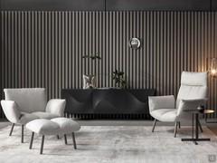 Example of a living room in dark tones with contrasting Pil armchairs by Bonaldo