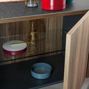 Outline is a sideboard by Bonaldo with a metal base and compartments equipped with glass shelves.