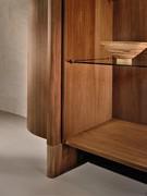 Detail of the plinth that continues vertically along the sideboard volume and forms the handle of the side door itself