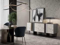 Elegant living room with sideboard Keramos from the blanc de blanc matte ceramic doors. The base with bronze-painted metal plates is coordinated with the sculptural bases of the Zentrum dining table