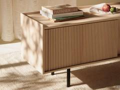 Detail of the sliding fronts of the Katen sideboard made with ribbed effect in solid ash