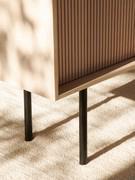 Detail of the solid ash wood structure of Katen sideboard, matched with the black metal base