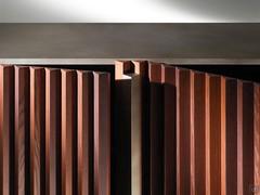 Slatted doors with hand-finished inlays, elegant textural contrast between frame and fronts