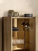 Detail of the interior of the Maia sideboard with mirrored back and glass shelves