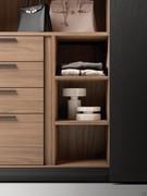 Detail of the interior equipment of the Focus Wide sliding closet. Shown here is a natural walnut veneer chest of drawers with divider and side shelves