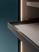 Detail of a pull-out tray and recessed vertical LED bars on the side: the interior is in oxford sand melamine