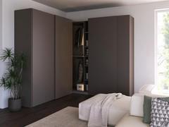 Variant of the Wide sliding corner wardrobe proposed with opaque lacquered groove opening to match the doors and interiors