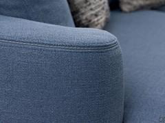 Detail of the piping finishing the upholstery cover and underlying the curved borders of the sofa