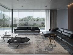 A large living room with two Maxime sofas in black leather, one in the linear version and one with the maxi chaise-longue