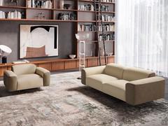 Linear sofa matched to the armchair of the same collection to create a more traditional styled living room