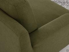 Detail of the meeting of the low armrest and the high backrest supporting the cushions