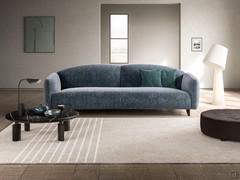 Gilmour 3-seater linear sofa characterised by shaped, curved backrests and high sabre-shaped wooden feet