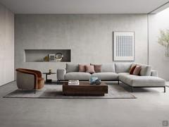 Modern sofa with meridienne corner, wide armrests and raised from the floor by self-supporting frame with metal feet