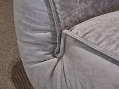 Detail of the connecting fold between seat and armrest emphasising the draped upholstery concept