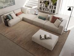 Paros sofa shown in a large L-shaped composition open on one side; alternating ottoman, corner element and backrest seating for modern, informal living