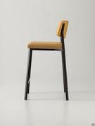 Side view of the Omnia stool in the upholstered version with plain backrest