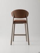 Rear view of the Omnia stool in the upholstered version with curved backrest