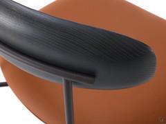 Detail of the tubular metal structure supporting the curved solid wood backrest