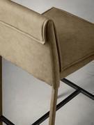 Detail of the seat and back upholstery. The top creates a pleasing fold toward the backrest with matching stitching