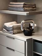 Close up of the platinum matt lacquer shelf with brackets in moka shine painted metal