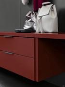 A desk positioned on top of a set of 2 drawers in Amaranth matt lacquer