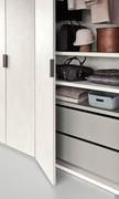 Inside of a hinged door wardrobe organised with shelves and drawers