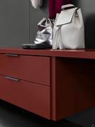 Suspended drawer unit supporting a desk made from matt lacquer in the Amaranth finish