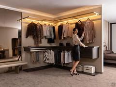 Walk-in wardrobe with Horizon Lounge rack system, with boiserie panelling and corner module