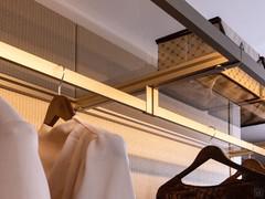 Metal and glass shelves with integrated LED lighting, available as part of the Horizon Lounge walk-in wardrobe equipment