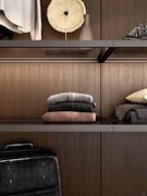 Metal-framed glass shelves to contrast the wood paneling of the Horizon Lounge walk-in closet