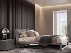 Lounge Boiserie wall panels with plissé finish, proposed as a full-height composition behind the headboard - a popular use for this type of product