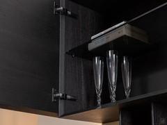 The inside of the wall unit is equipped with a practical shelf made from smoked glass