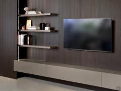 Lounge shelf for a wall system, paired with a suspended TV on the full-height Lounge wall panels