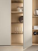 Lounge wardrobe column equipped with glass and wooden shelves, matching the interior