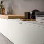 Detail of the storage element for the living room with drawers called Plan equipped with top and M handle in white metal