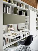 Way 23 wall system with white lacquered glass sliding door and foldaway desk