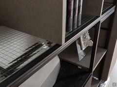 Detail of the container shelf with iron Wax structure and panels in armed glass characterised by a grill of metal wires